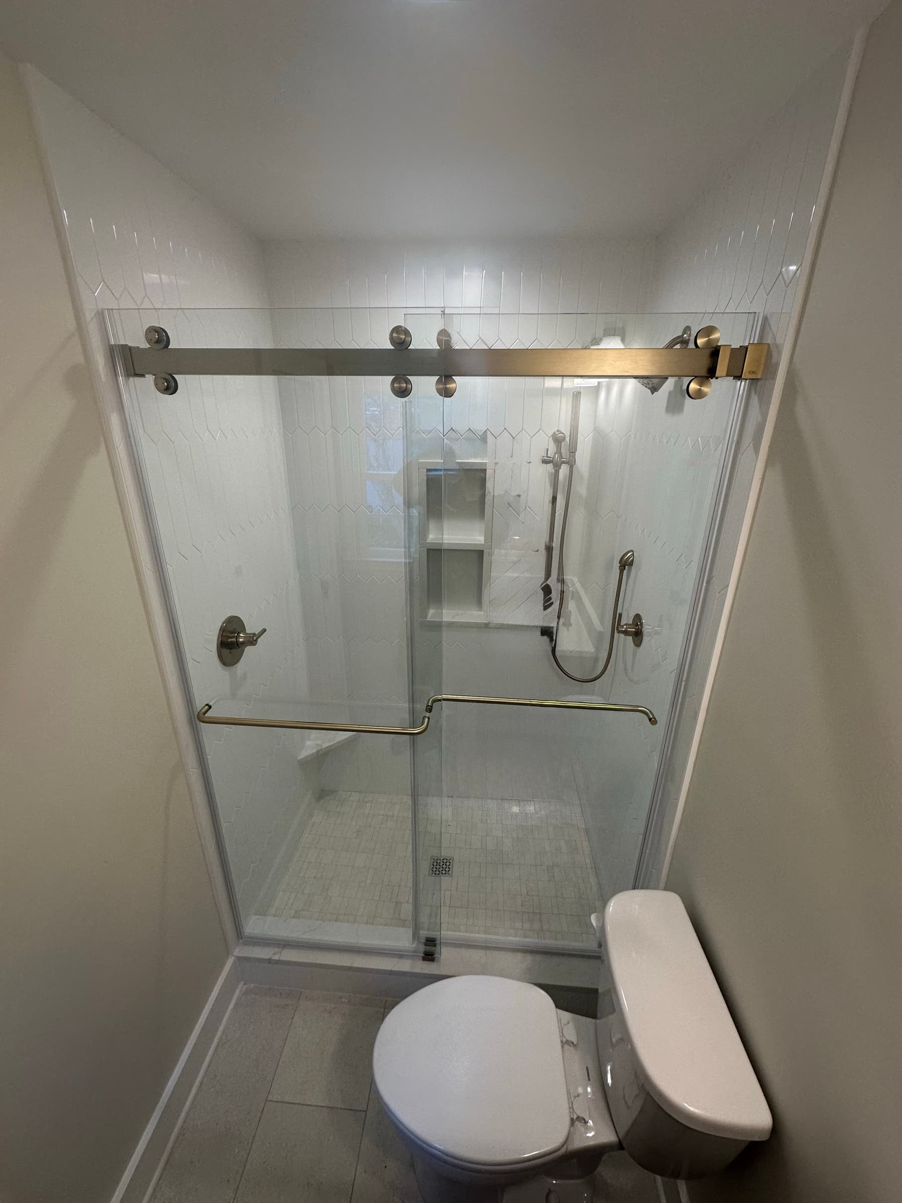 Decorative gold barn-door style glass shower door by DgGlass